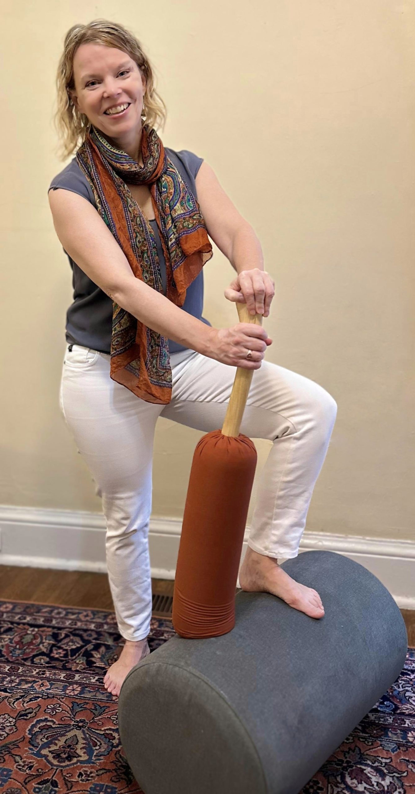 Beth with some tools that we use in Core Energetics - a bataka and a roller